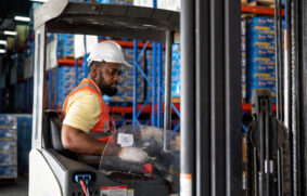 forklift-truck-operator-lifts-pallet-cardboard-box-2022-12-01-06-09-35-utc